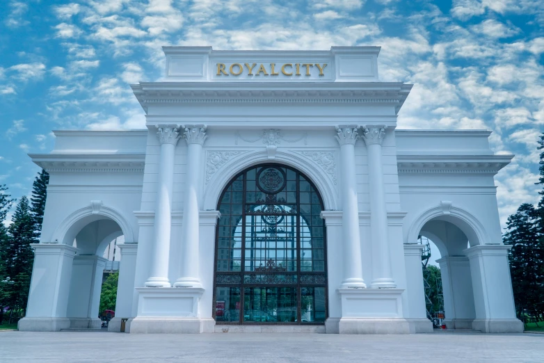 the entrance to the royal city in front of trees