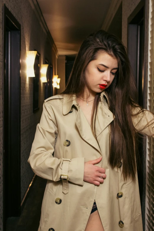 a person standing in a hallway with a jacket on