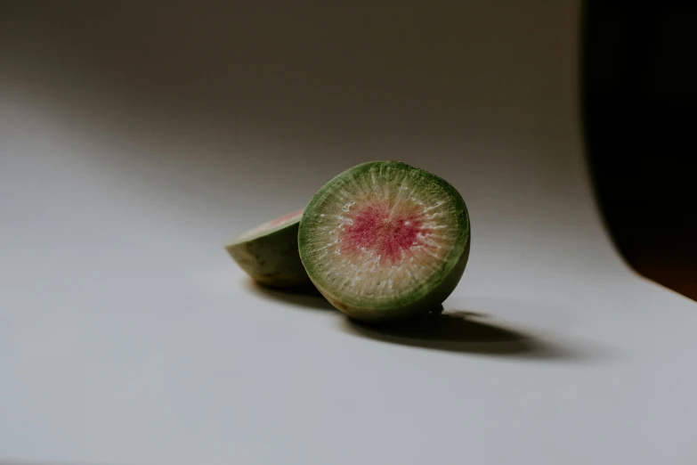 a half - peeled kiwi on a white background