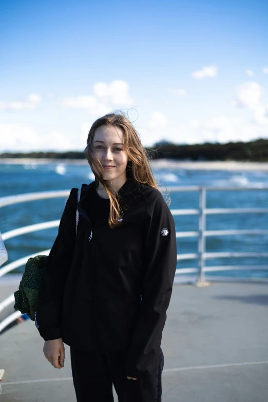 a person wearing an oversize hoodie on a ferry