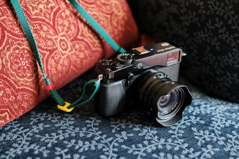 an old camera and some small cord with its strap