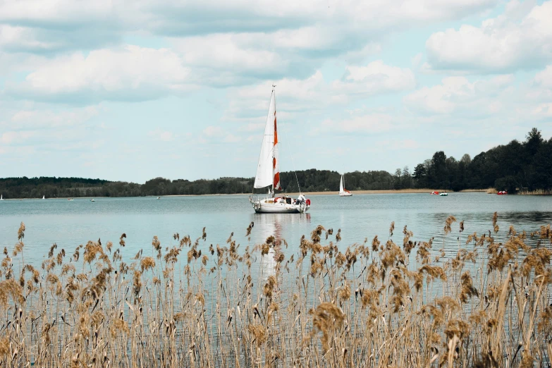 a sail boat floating on top of a lake