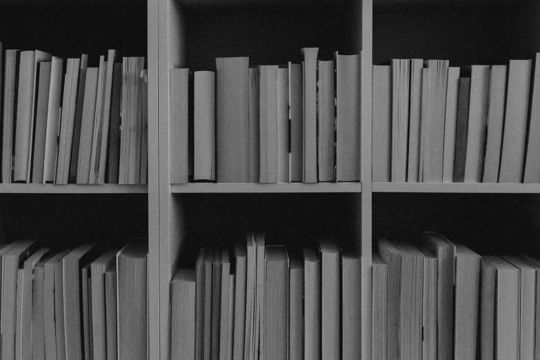 a bookcase with many books sitting in it
