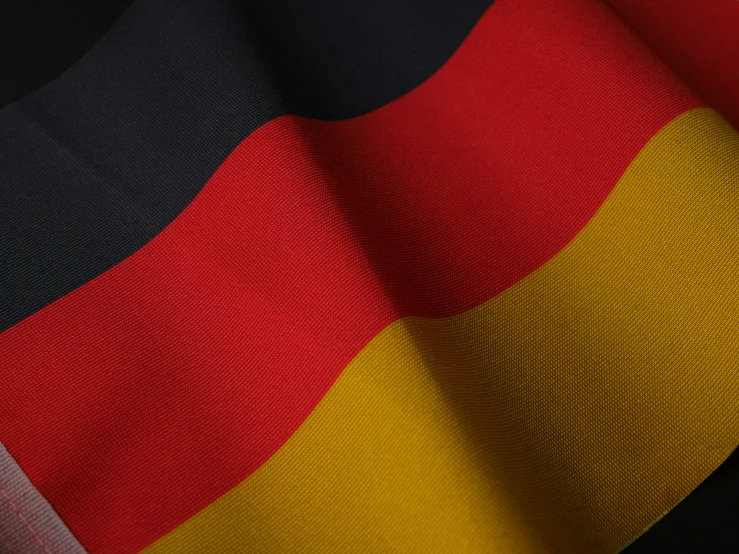 the fabric has a striped design that is orange, red, black, and yellow