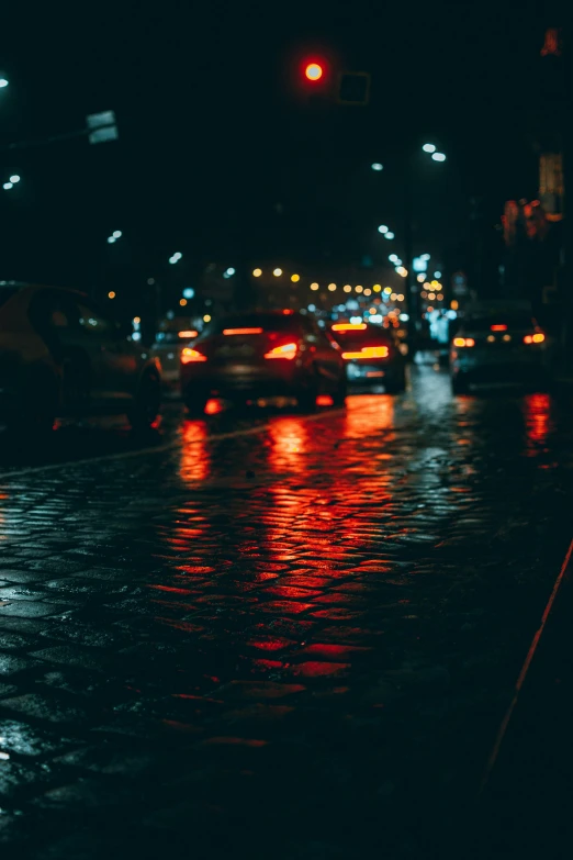 city street at night with cars moving at it's headlight