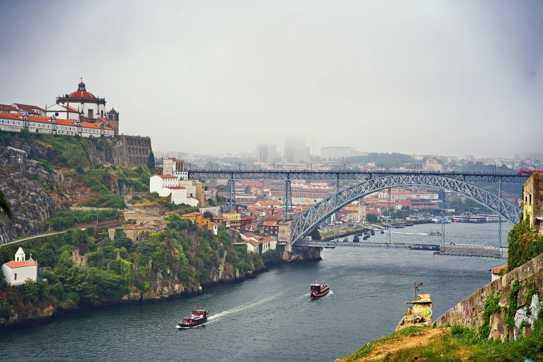 the boats are passing under the bridge on the water