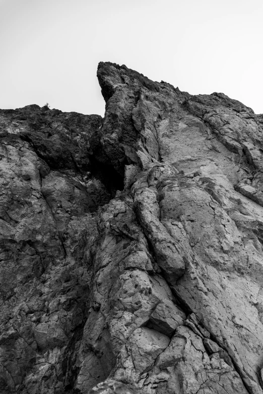 person on top of a rock, flying a kite