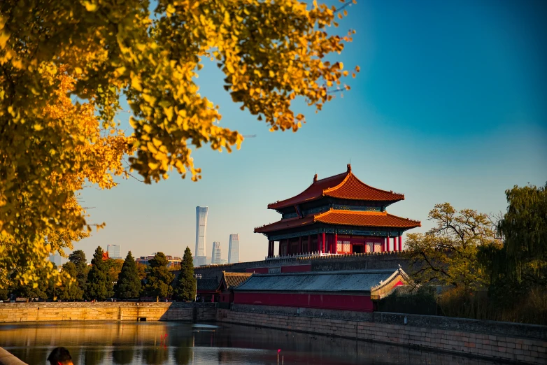 a view of an asian pagoda by the river