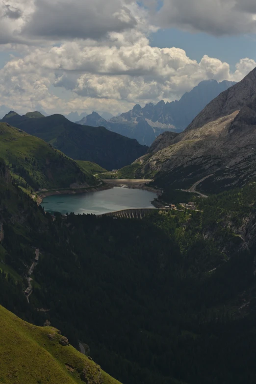 the view from a high cliff overlooking a lake and mountains