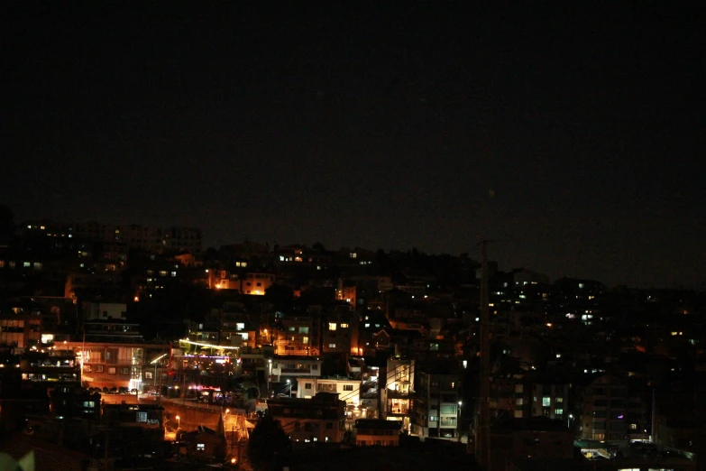 a city lit up at night with lots of light from buildings