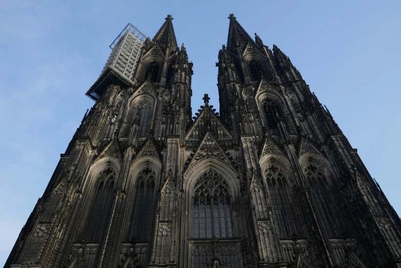 a very tall cathedral with lots of windows and a clock at the top