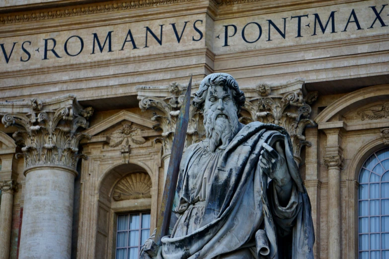 a statue of a man in front of a large building