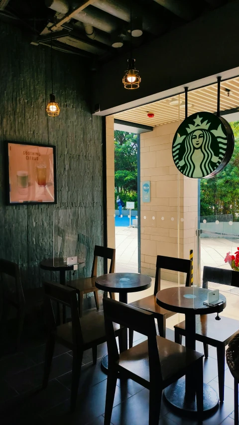 a restaurant with wooden chairs and two glass windows