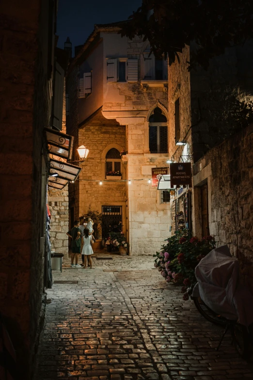 two people standing on the side walk at night