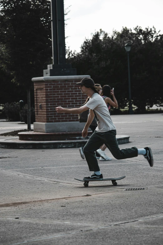 the young man is riding his skateboard down the street