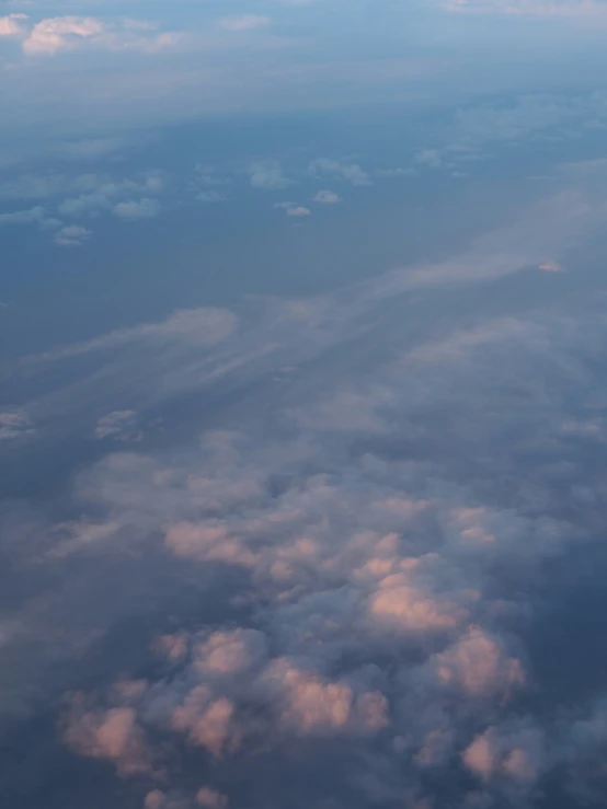 view from the airplane of clouds from above