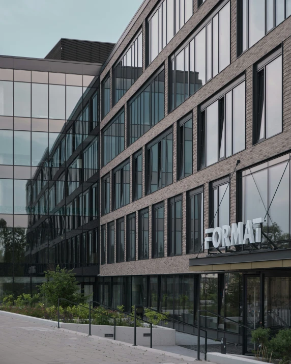 a tall building with an elegant metal sign on the front