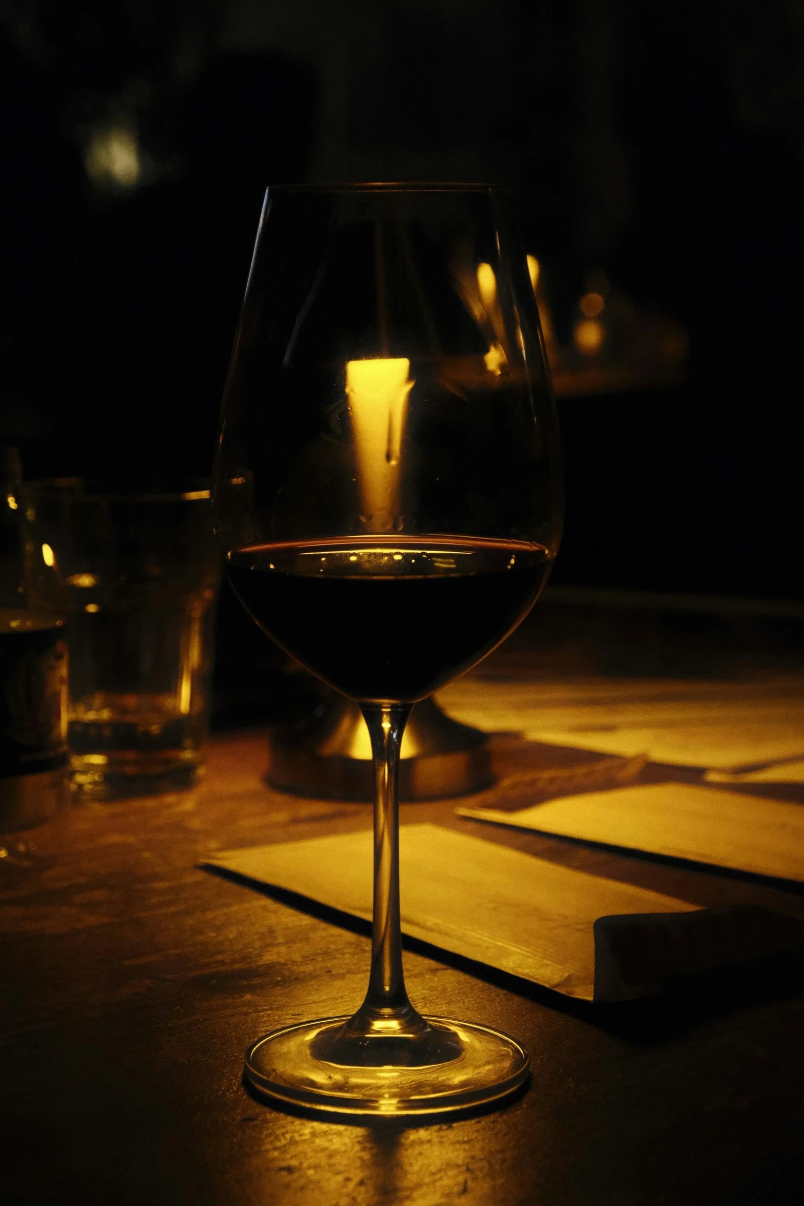 dark po of a glass of wine on a table