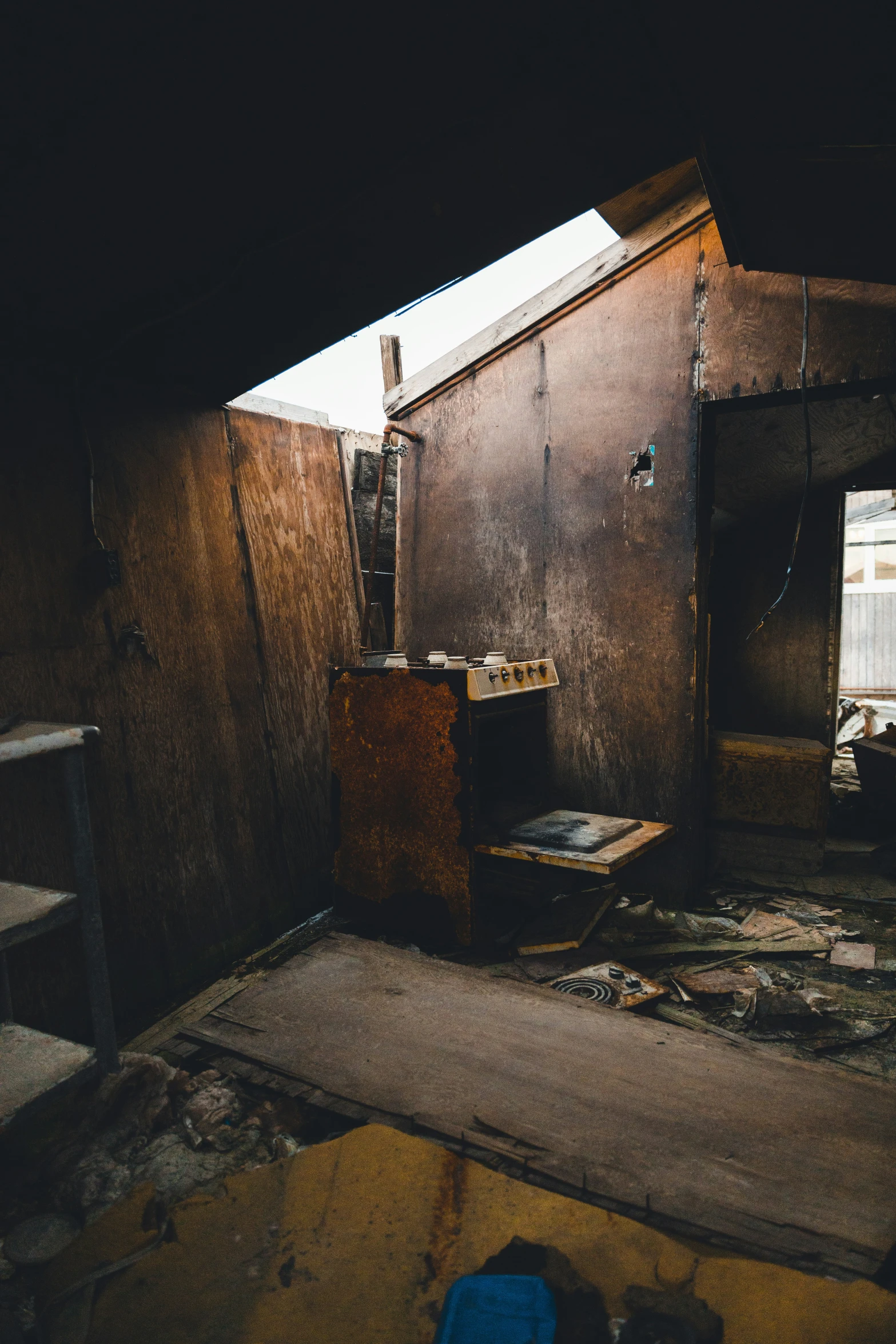 a run down room with a wooden door and skylight