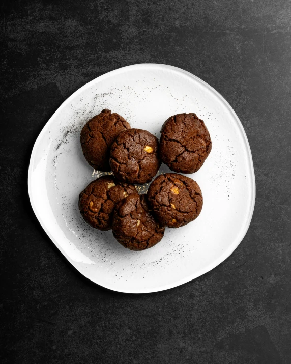 five cookies on a plate in dark chocolate