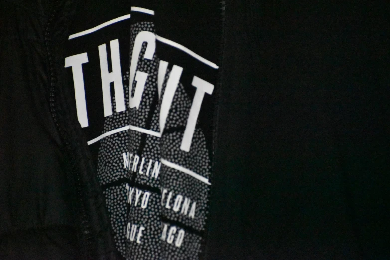 the back view of the logo on a dark jacket