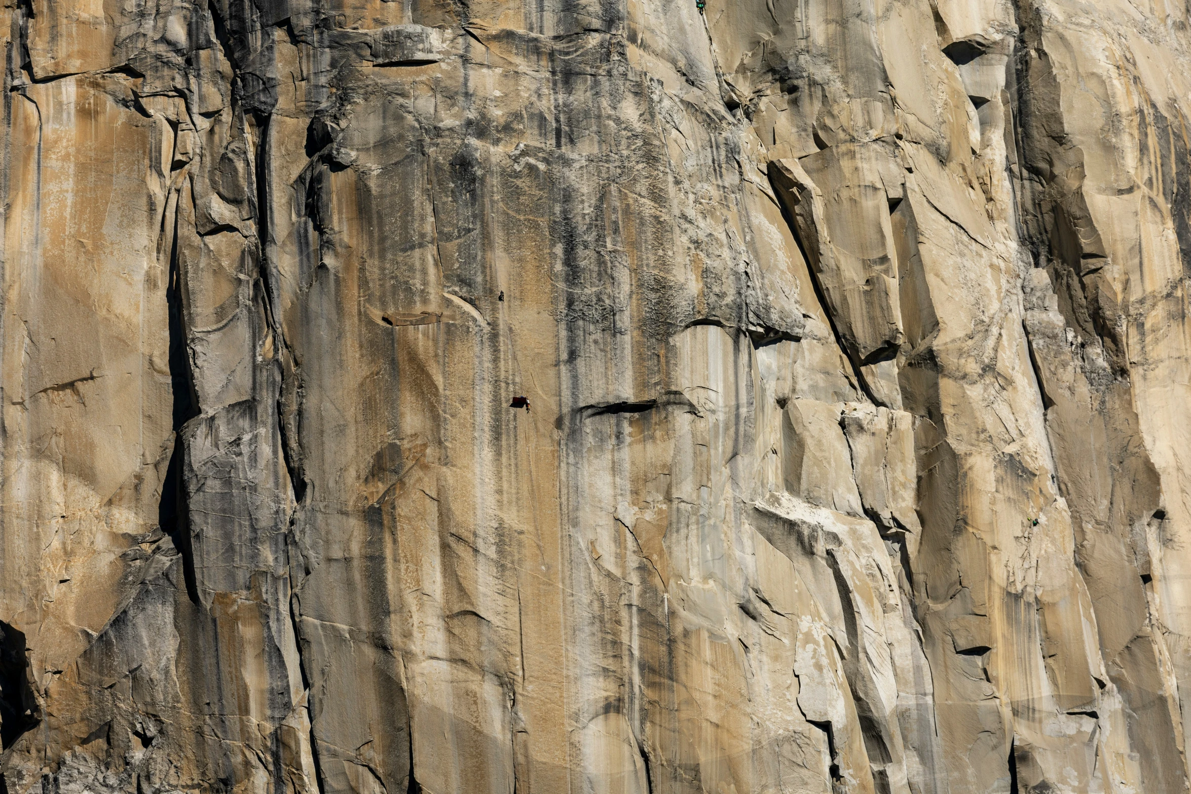 a man climbing up a steep mountain side