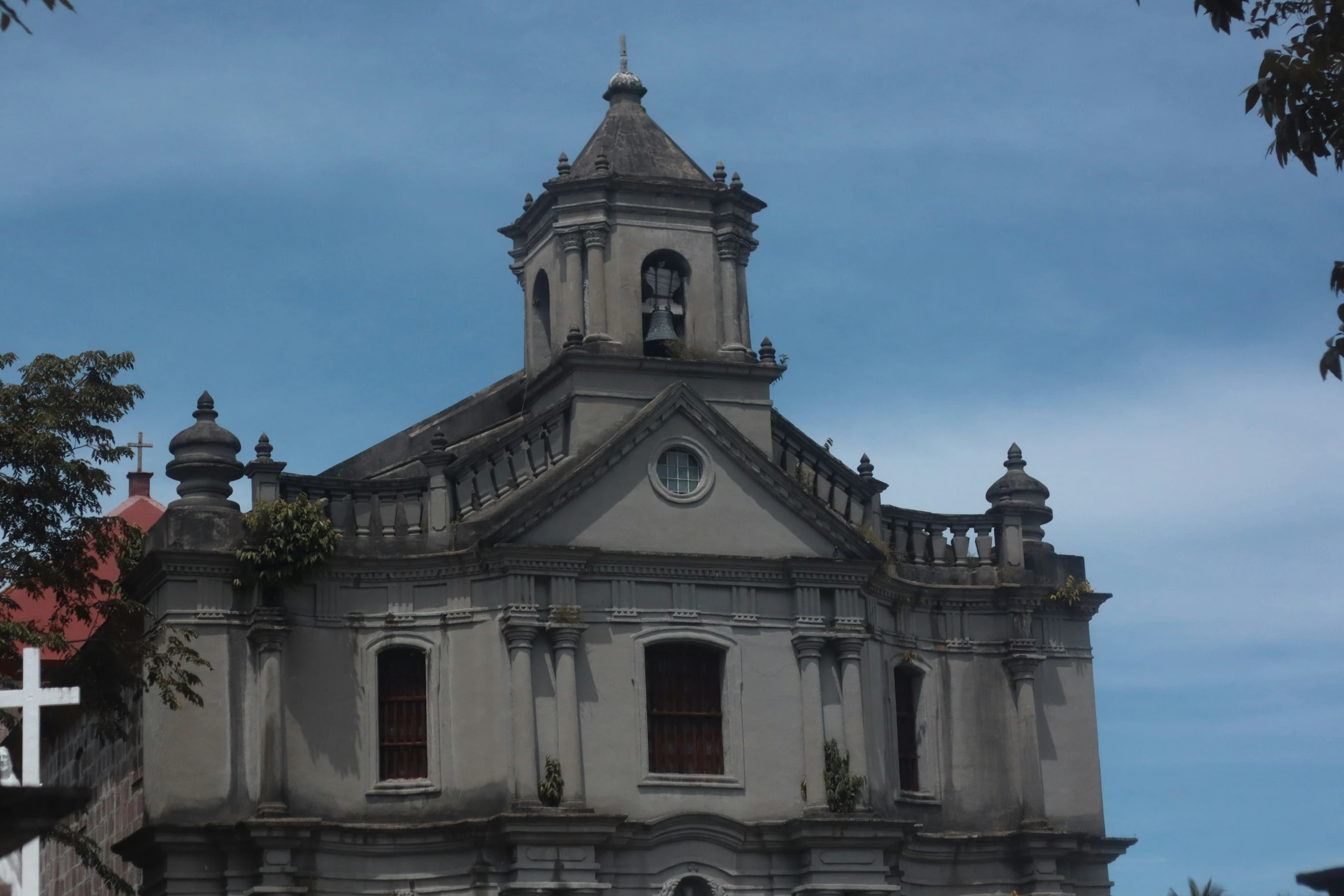 a large grey and white building with a cross on it