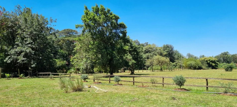 a large open field with a wooden fence