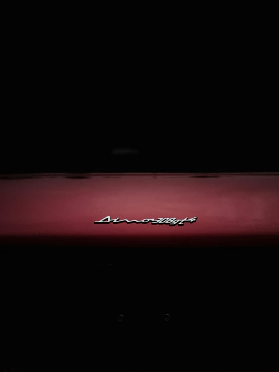 red chevrolet logo on red car front in dark room