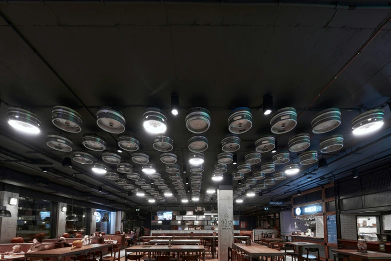 there is a very large dining hall with many plates hanging from the ceiling