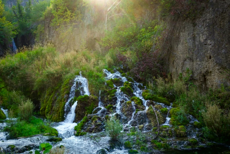 a waterfall cascading down a cliff near water