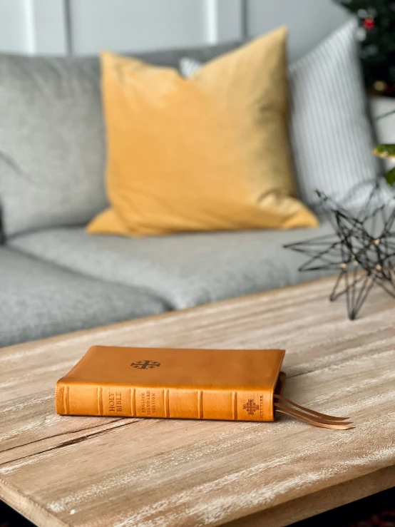 a leather notebook resting on a coffee table