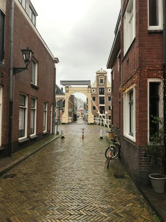 an empty, bricked street with no cars or people on the sidewalks