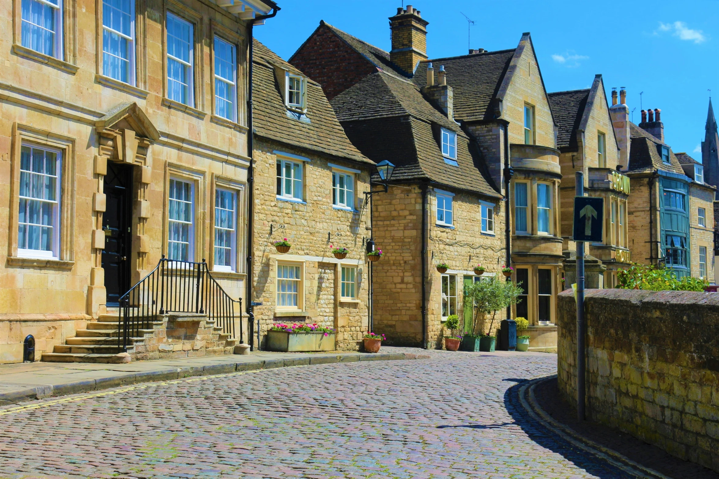 a street lined with old homes and buildings on a sunny day