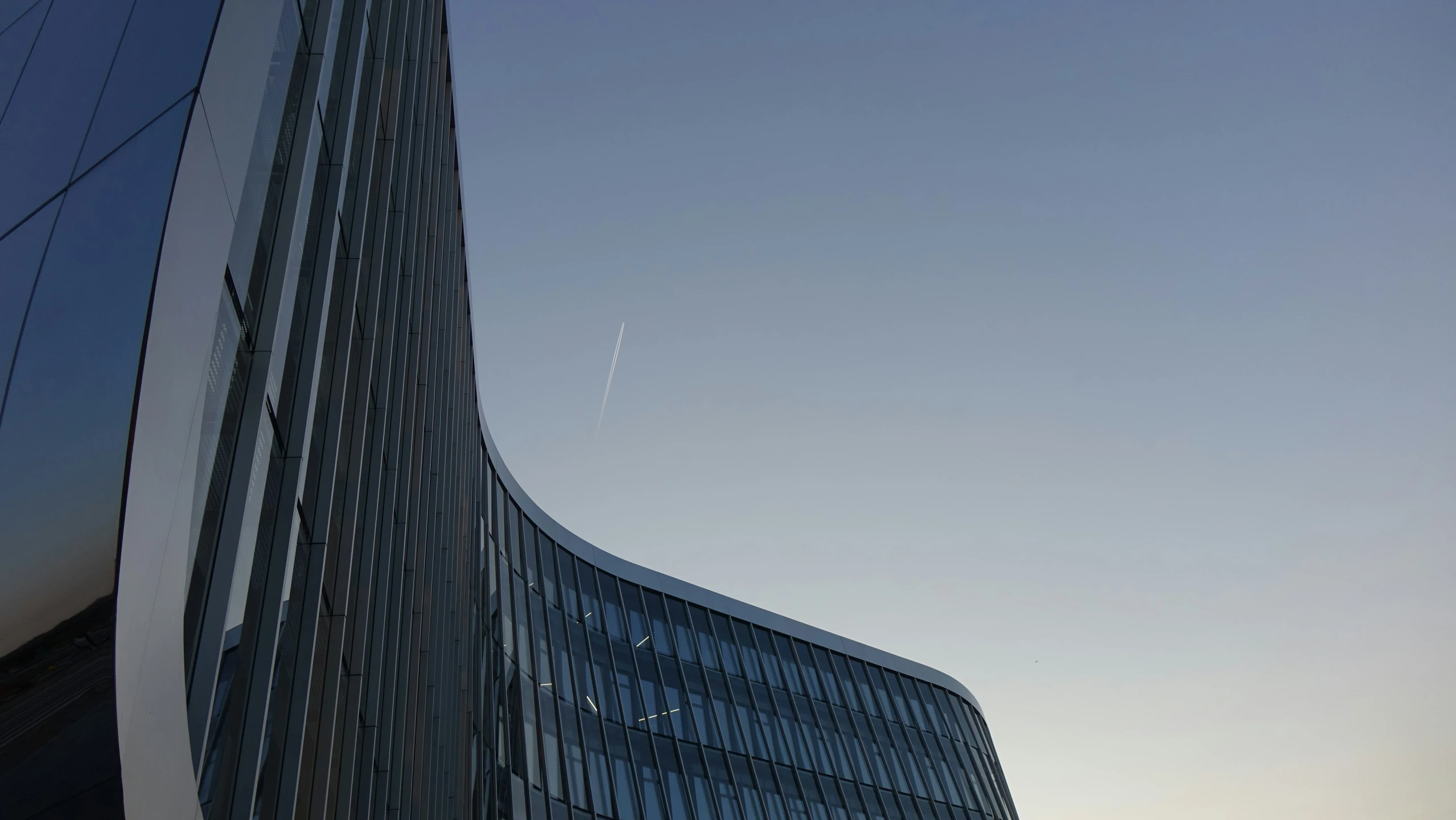 a very large tall building next to a sky line