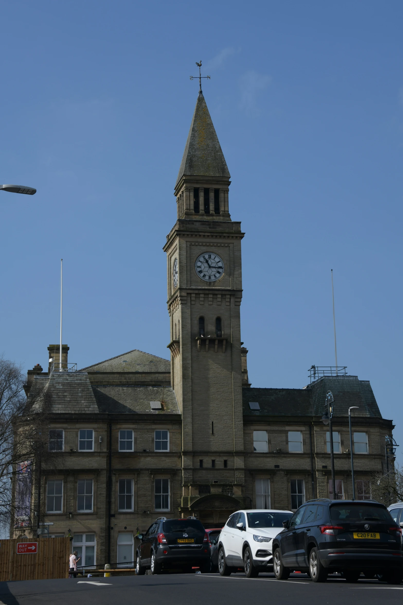 an old clock tower stands next to a building