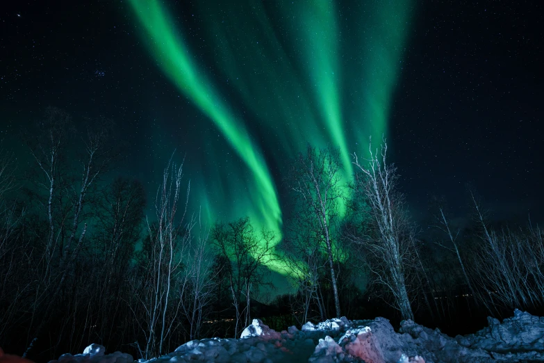 the aurora bore is being lit by an intense, green streak