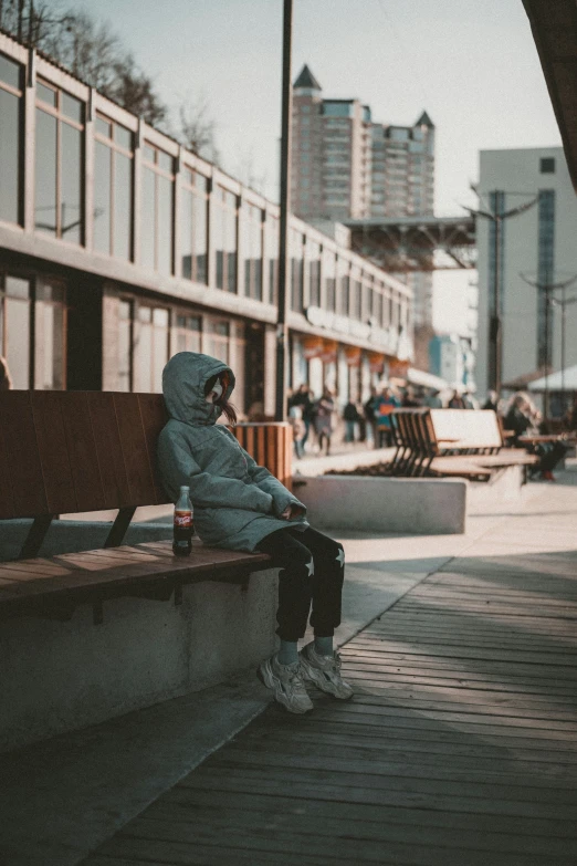 a person sitting on a bench in front of a building