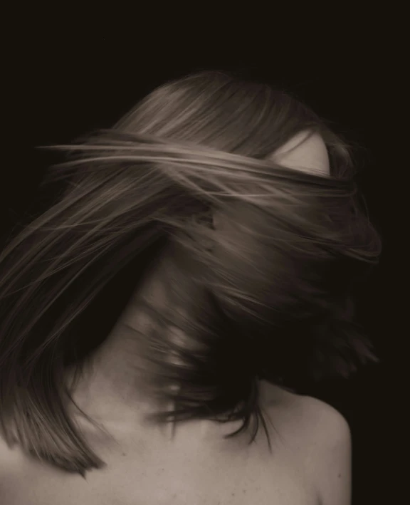 a black and white po of the back of a woman's head