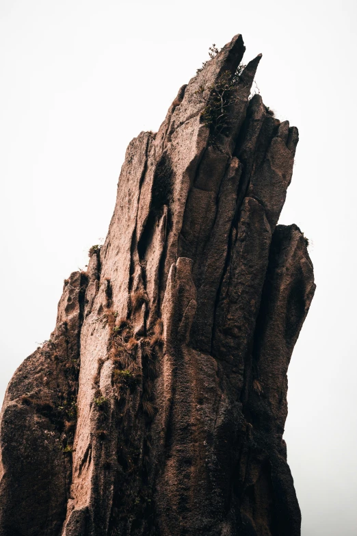 there are some very tall rock formations on a beach