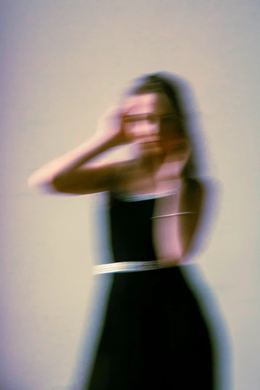 a girl in a dress with blurry face and hand