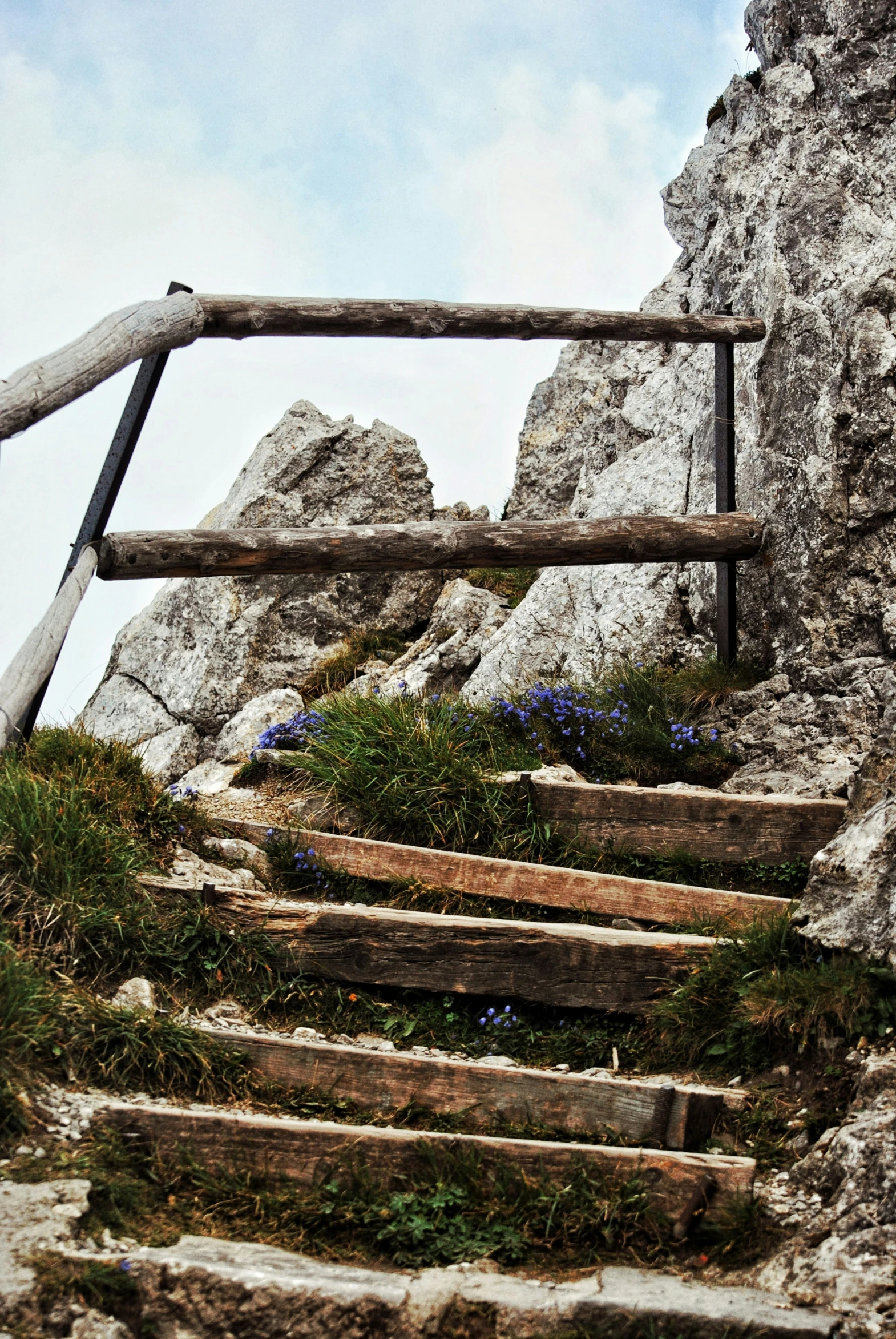 some stairs made from wood in a rocky cliff