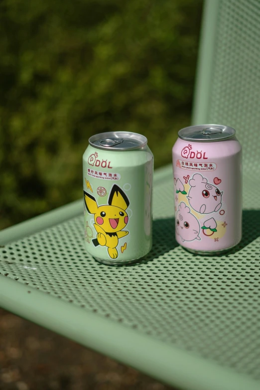 two pokemon - themed soft drinks sit on a bench