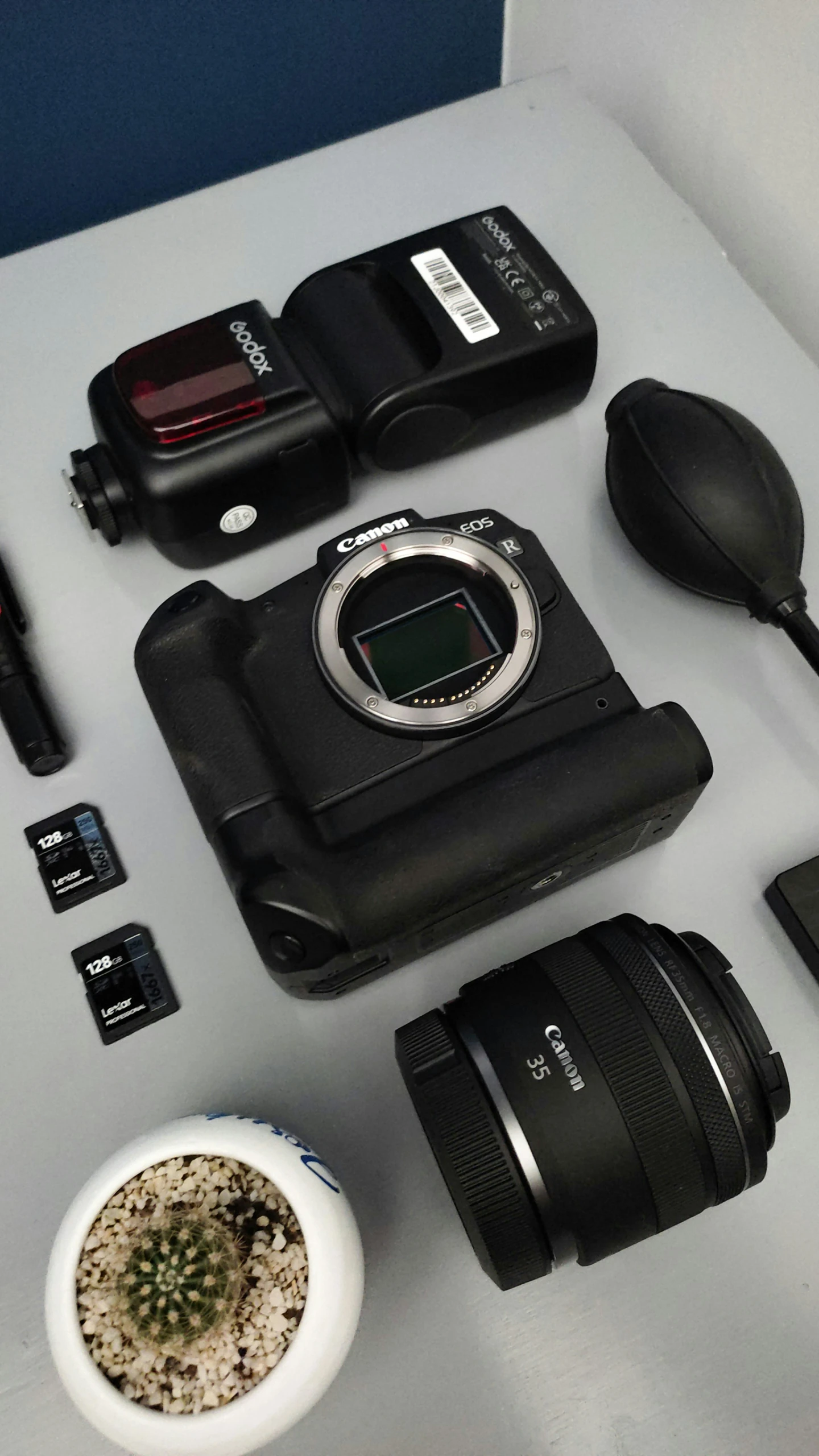 various cameras, batteries, and other items sitting on a table