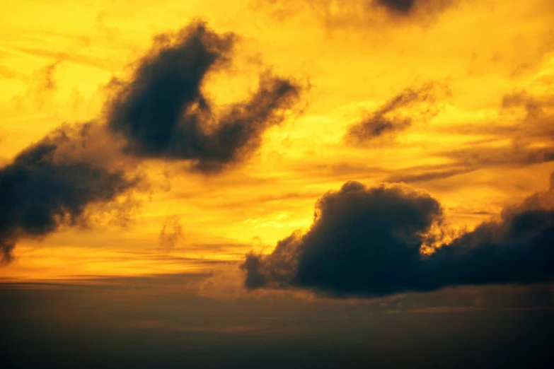 an orange and yellow sunset showing the clouds