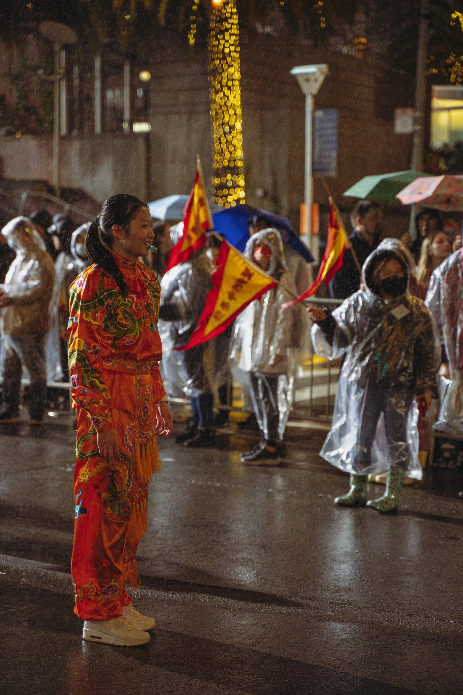 a woman standing in the rain under an umbrella