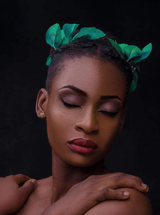 woman with green leaves on her head and chest