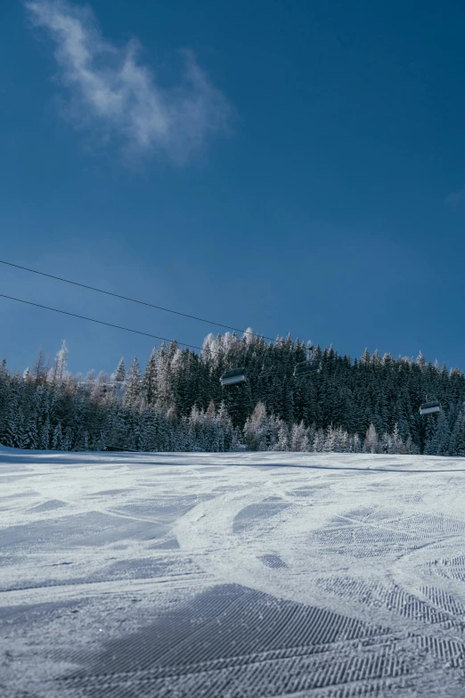 someone in skis is looking across the snow - covered field