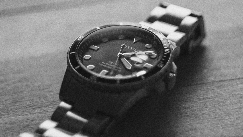 a watch with black and white stripes sitting on the floor