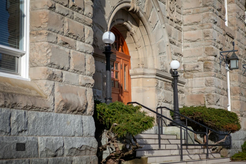 an arched door and windows with steps leading to it